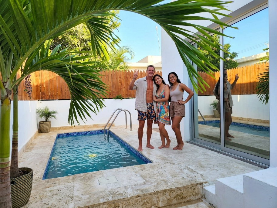 Guests enjoying the private pool and palm trees at Marimar Beach House